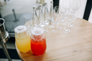 Summer cool lemonade in a glass jug stands on the table