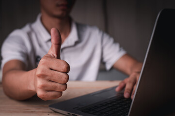 A man sat and worked and displayed a thumb, a wonderful symbol, working at home concept, working concept in office.