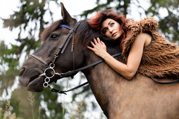 Woman horse riding in forest brown