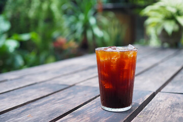 A beautiful ice black coffee served with plastic glass. Selective focus. blur background