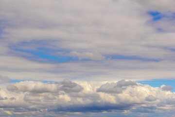 Light cumulus clouds in the blue sky.