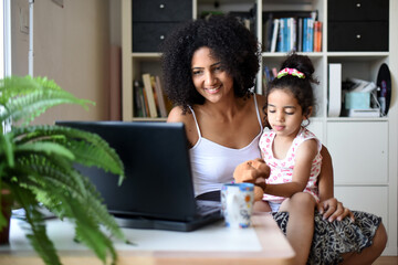 metis mother working home with her daugther