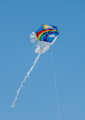 Rainbow Patterned Kite Flying In The Air