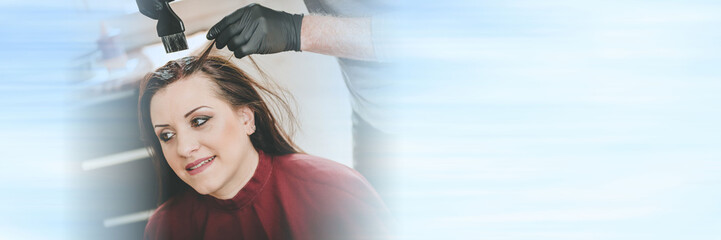 Fototapeta premium Hairdresser coloring hair; panoramic banner