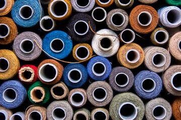 Bright spools of thread. Many coils create a background