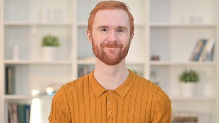 Portrait of Redhead Man saying Yes by Shaking Head