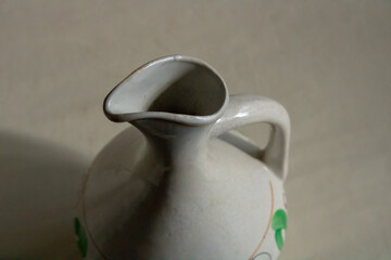 Decorative porcelain jug with a handle on a cloudy day.