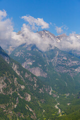 Val Bavona valley in Swiss Ticino alpine mountains with clouds, blue sky
