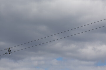 Number 6 on a background of white clouds