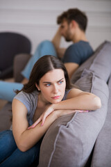 Obraz premium Young woman sitting with a depressed look after a bad talk with her husband