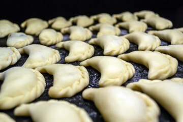 Dumplings with mushrooms, on a black background