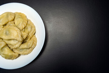 Dumplings with mushrooms, on a black background