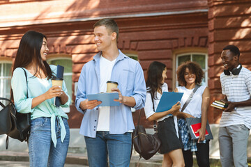 College Life. Joyful Students Chatting Outdoors During Break In Classes