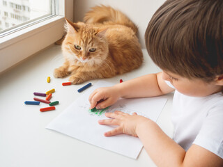 Toddler draws colorful robot. Kid uses wax crayons to paint it. Cute ginger cat lies on window sill with child. Coloring pages to train fine motor skills.