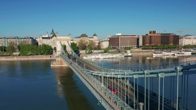 Budapest, Hungary - 4K drone flying above the beautiful Szechenyi Chain Bridge on a busy and sunny summer day