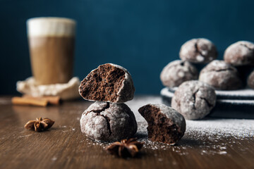 A few marble brown cookies with glass of coffee latte, star anise and powdered sugar