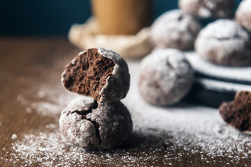 A few marble brown cookies with glass of coffee latte, and powdered sugar
