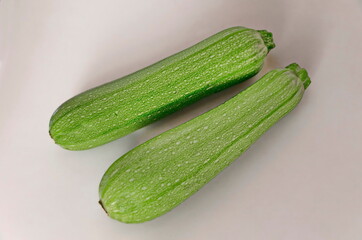Fresh raw zucchini, courgette, Cucurbita  or squash vegetable marrow on a white background, Sofia, Bulgaria 