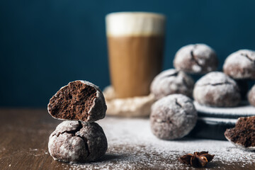 A few marble brown cookies with glass of coffee latte, star anise and powdered sugar