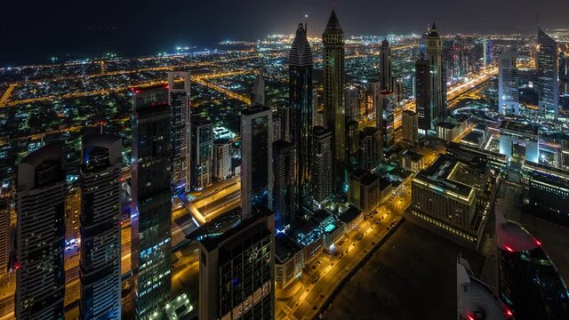 Amazing timelapse at night from index towers in Dubai UAE with big Sheik Zhayed road car passing in slow shutter static shoot