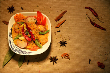 'Dal fry' an Indian delicacy served with red and green chilies and onions, on a textured background.