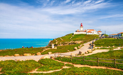 Fototapeta na wymiar Cabo da Roca, Portugal. Lighthouse and cliffs over Atlantic Ocean. The most western point of the European continent.