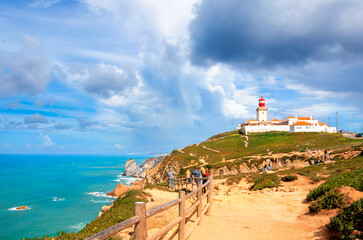 Fototapeta na wymiar Cabo da Roca, Portugal. Lighthouse and cliffs over Atlantic Ocean. The most western point of the European continent.