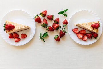 Strawberry and mint composition. Top view of tasty cheesecake and organic strawberries laying on white table background with place for text. Happy father's day gift. Holidays. Valentine's day. 