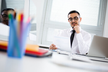 Young handsome arab businessman working alone in the office