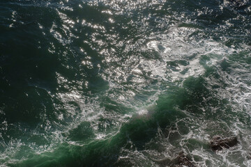 Ocean wave background breaking sea water rocky shore