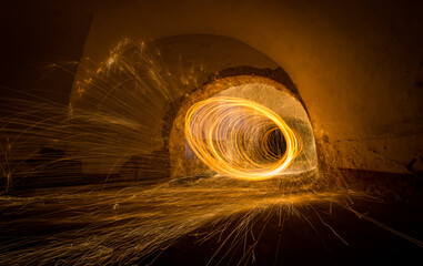 Painting with light - fire spinning in closed space - light lines