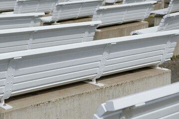 several empty white wooden benches