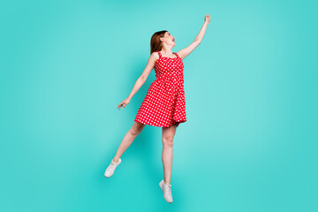 Full length photo of positive cheerful girl jump want catch air fly parasol hold hand wear good...