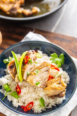 Chicken roasted with a skin on, cut to pieces, served with rice, chilli and parsley