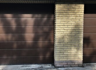 background texture closed garage gates of a private house made of aluminum rollers with brown...