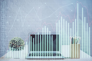 Double exposure of graph and financial info and work space with computer background. Concept of...