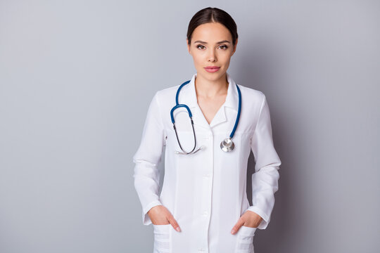 Photo of attractive family doc virologist experienced skilled professional hands pockets reliable worker wear medical uniform lab coat stethoscope isolated grey background