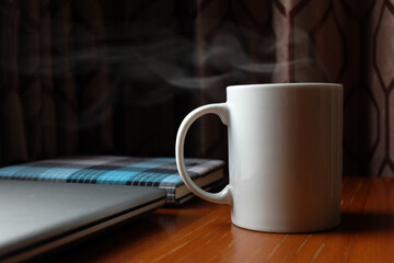 Hot coffee cup on working desk, Drinking with vapor, food and drink background concept  for your design work, presentation, website or others.