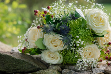 Cream rose bouquet on stone wall