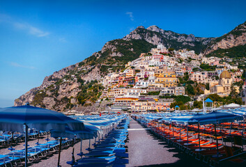 Blue beach umbrellas, chairs, deck chairs. Places to relax by the sea. The concept of quarantine and the beginning of the tourist season, preparation for the arrival of tourists.. Positano Italy