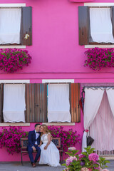 Fototapeta na wymiar beautiful wedding couple posing outdoor in front of house