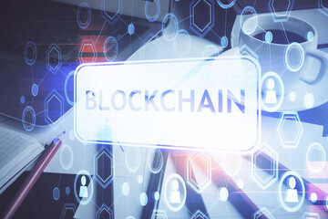 Multi exposure of blockchain and crypto economy theme hologram and table with computer background....