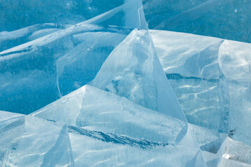 Abstract ice cracks of frozen Baikal lake of blue color