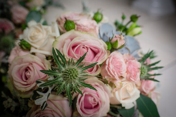 Close up of flower bouquet with pink roses and thistles