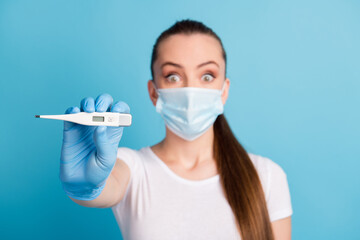 Closeup photo of beautiful shocked fear lady hospital examination thermometer high temperature sick covid wear protect face medical mask white t-shirt isolated blue color background