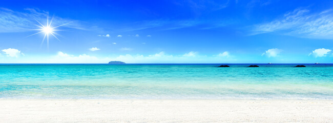 World Environment Day concept: Beautiful beach with white sand, turquoise ocean water and blue sky with clouds in sunny day