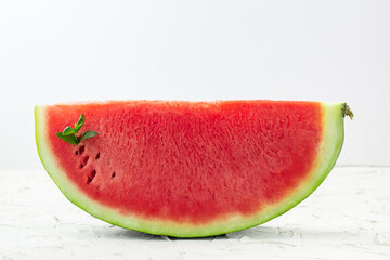 Sliced of fresh red ripe watermelon with mint on white background