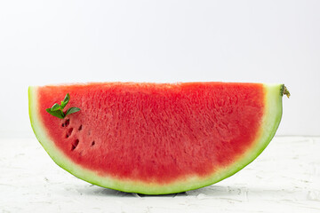 Fototapeta na wymiar Sliced of fresh red ripe watermelon with mint on white background
