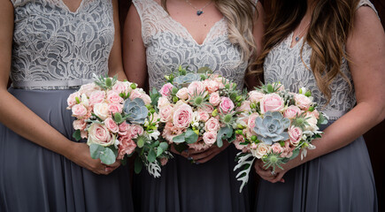 Bridesmaids holding flowers close up