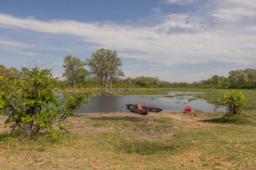 Canoeing  traditional Mokoro boats on the Khwai River in the Moremi Game Reserve Botswana